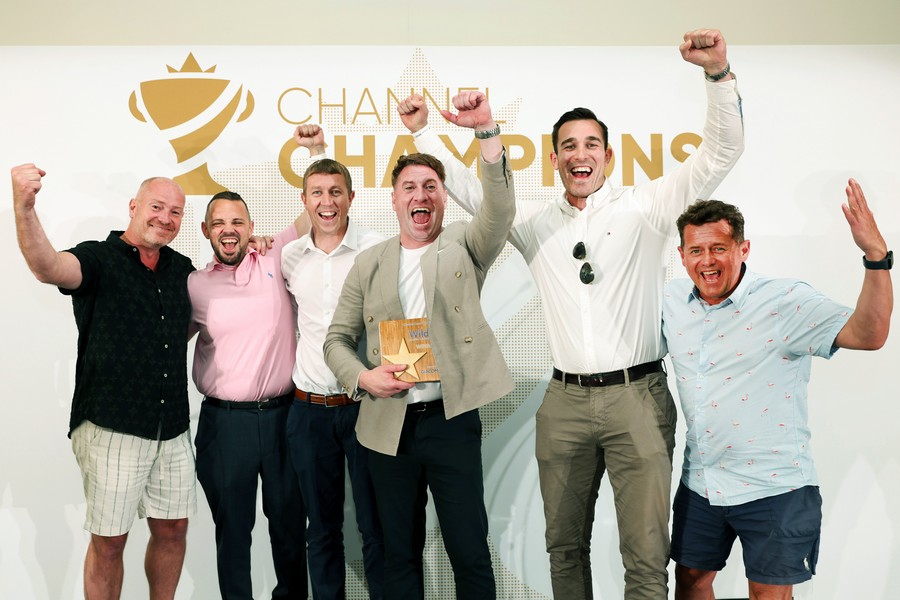 Winners of an award holding a trophy