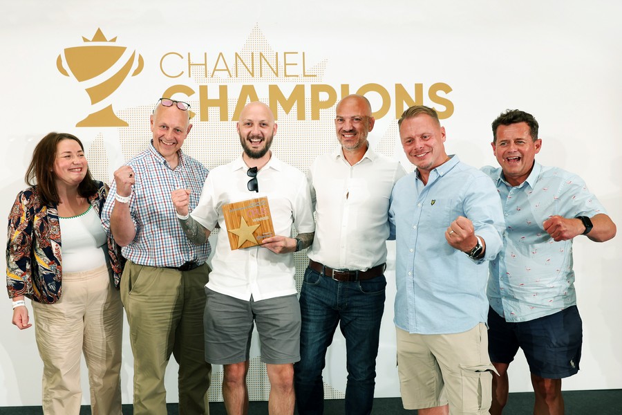 Winners of an award holding a trophy