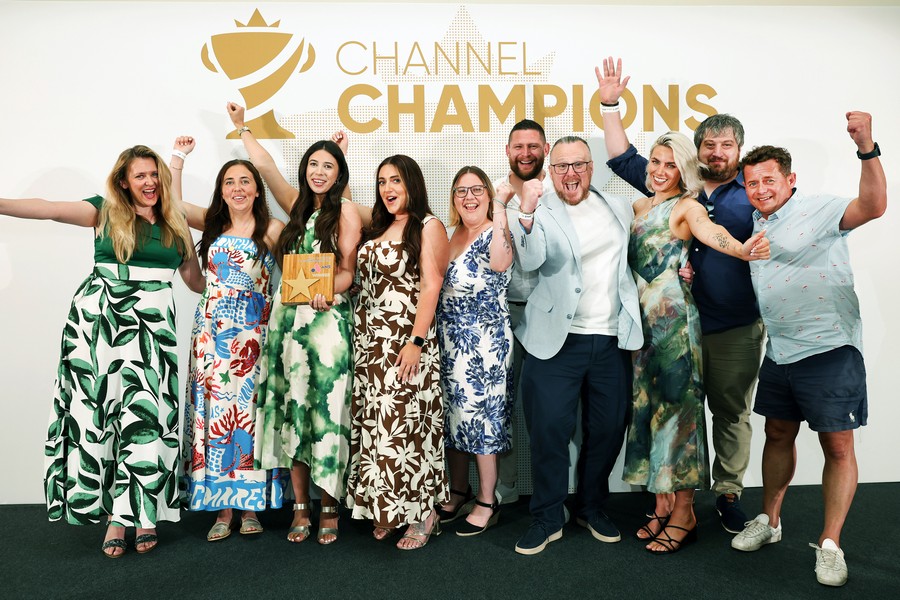 Winners of an award holding a trophy