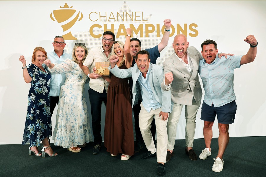 Winners of an award holding a trophy
