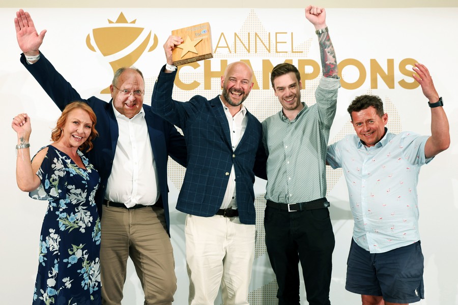 Winners of an award holding a trophy