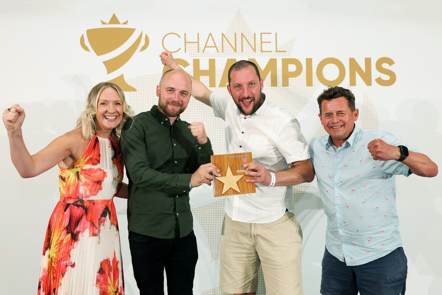 Winners of an award holding a trophy
