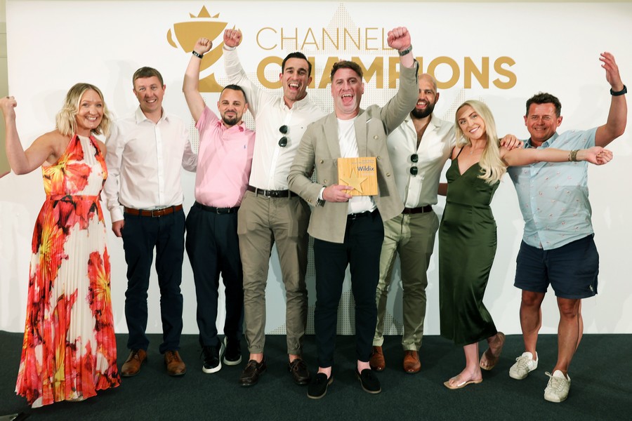 Winners of an award holding a trophy