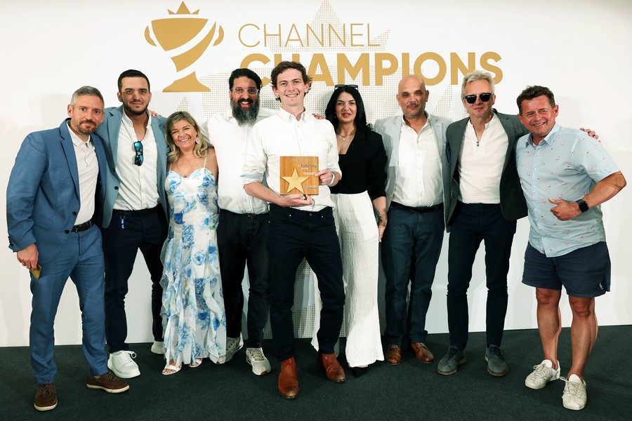 Winners of an award holding a trophy
