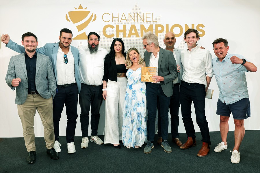Winners of an award holding a trophy