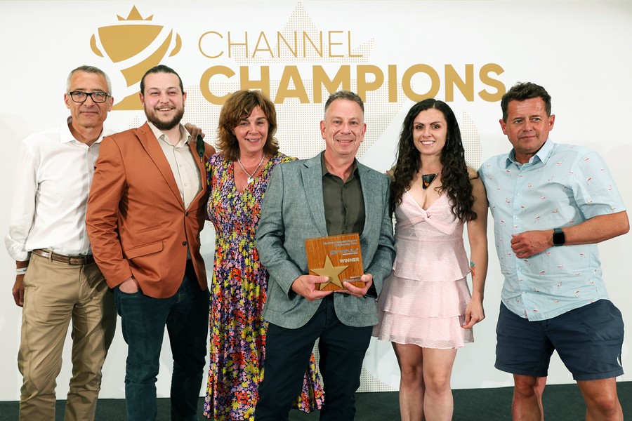 Winners of an award holding a trophy