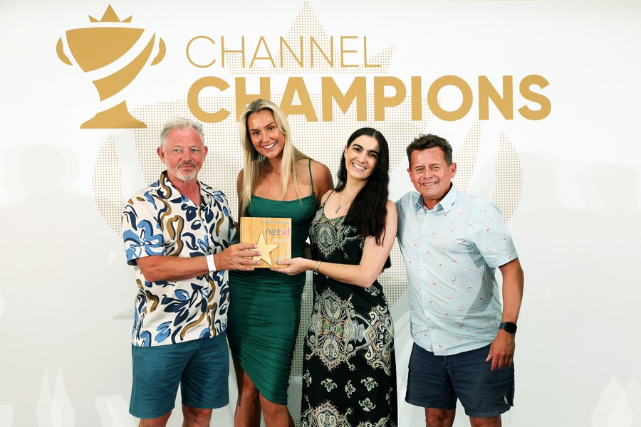 Winners of an award holding a trophy